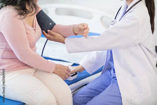 The doctor is using a blood pressure monitor on an elderly patient to check whether the blood pressure is abnormally high or not because hypertension often happens to the elderly and is dangerous.