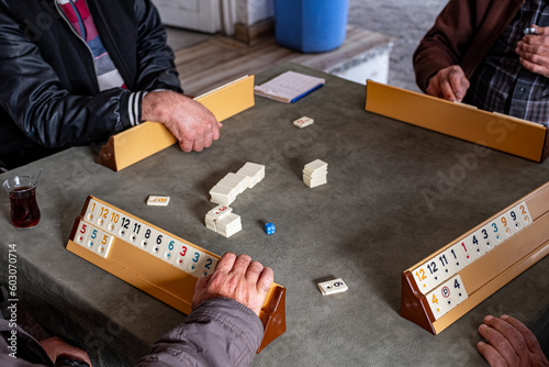 group of anonymous elderly man playing a board game photo