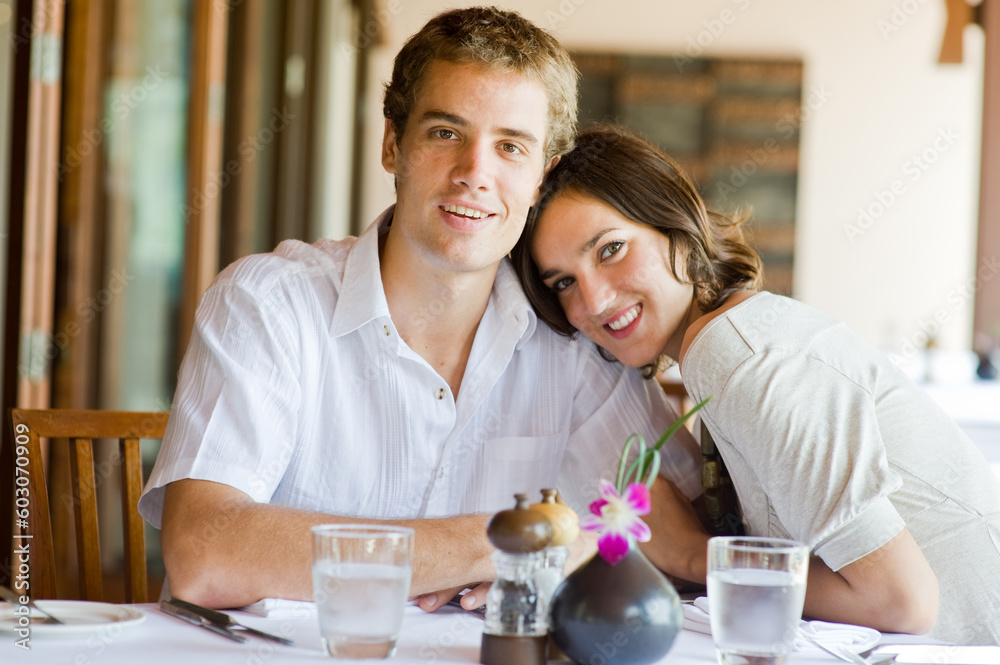 A young couple sitting together in a restaurant A young couple sitting together in a restaurant