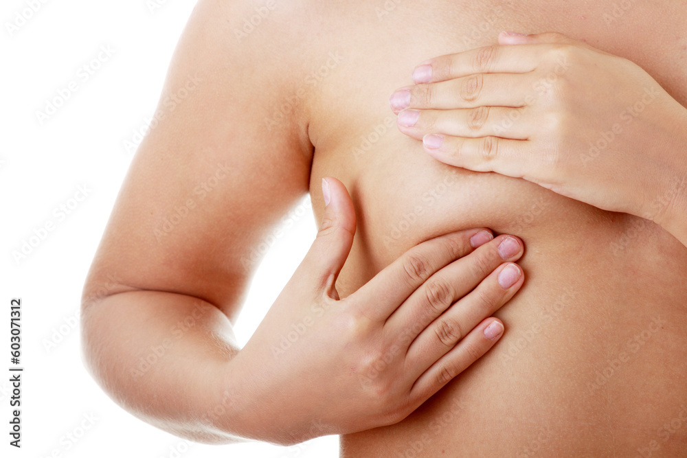 Young Caucasian adult woman examining her breast for lumps or signs of breast cancer Young Caucasian adult woman examining her breast for lumps or signs of breast cancer