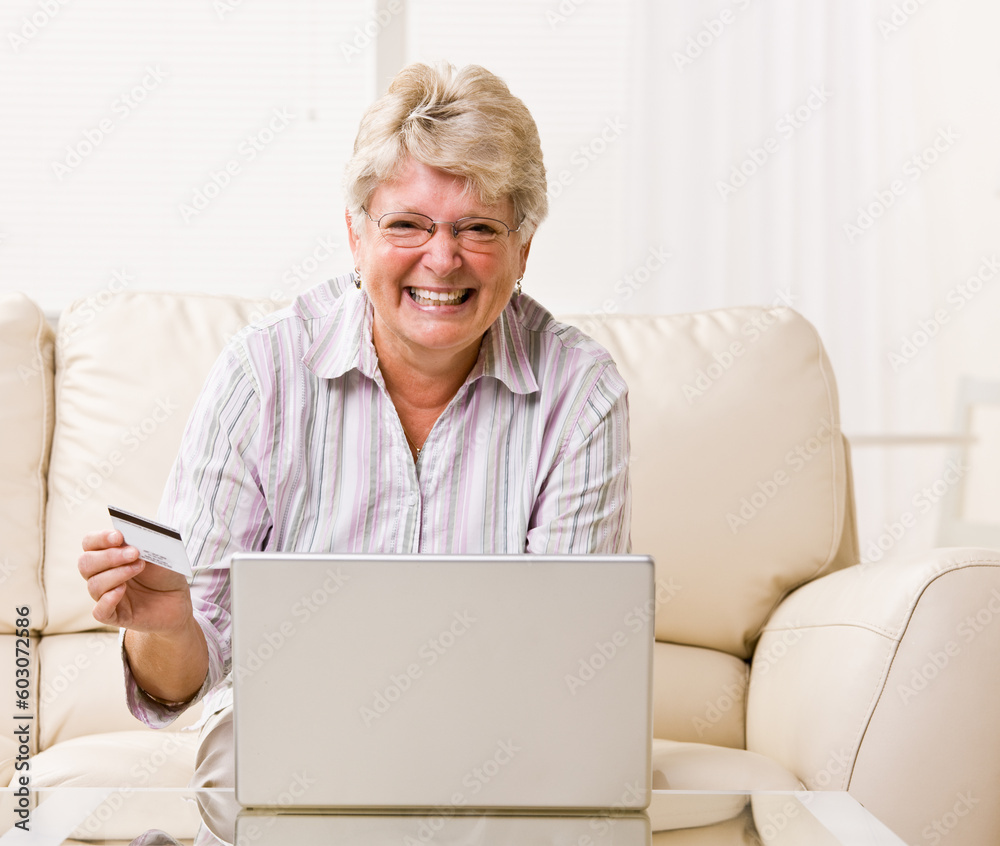 Woman using creditcard to buy internet merchandise Woman using creditcard to buy internet merchandise