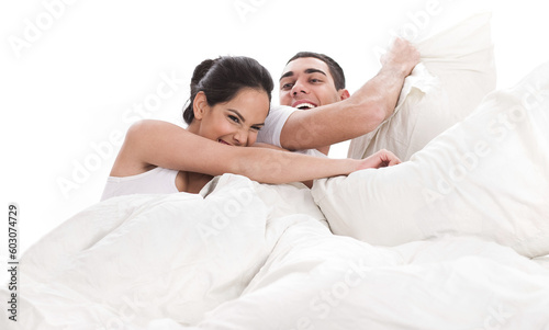 Playful young beautiful couple with pillows in bed cover white sheet