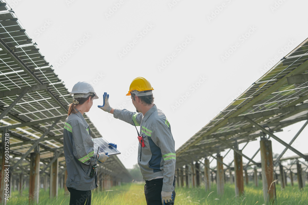 Engineers Meeting to check solar panel at roof top. solar farm with an energy storage system operated by Super Energy Corporation Specialists Gathered for Outdoor testing Photovoltaic cells module. - obrazy, fototapety, plakaty 