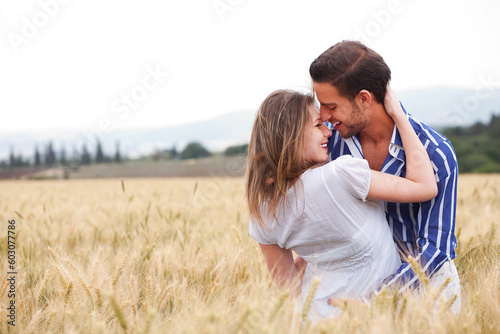 young Couple smiling eachotherr in the meadow