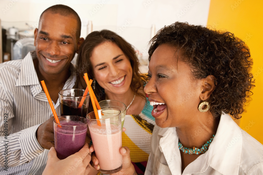 Two couples at a cafe drinking frozen beverages. Horizontal shot. Two couples at a cafe drinking frozen beverages. Horizontal shot.