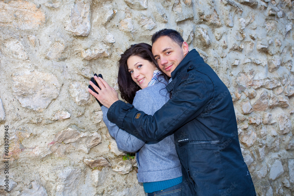 Young couple playing around in the nature - front view.