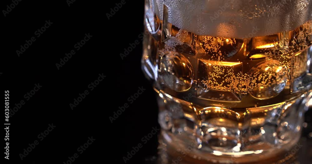 Beer in the glass. Alcohol. Fresh light beer passes behind the glass of beer, air bubbles can be seen in the glass. Advertising shot for packshot. Beer in the glass. Alcohol. Fresh light beer passes behind the glass of beer, air bubbles can be seen in the glass. Advertising shot for packshot.