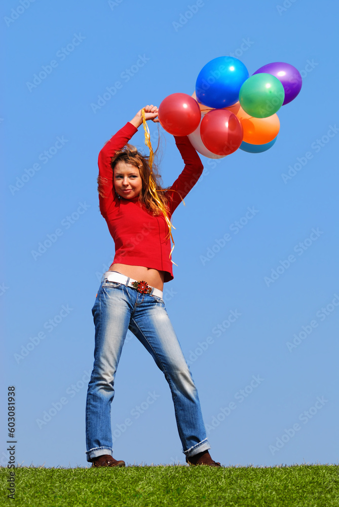 Girl with balloons against blue sky