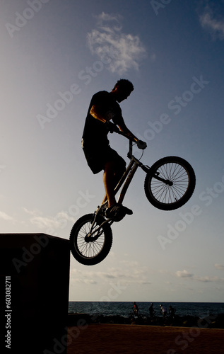 young in bicycle jump in street trial outdoor circuit