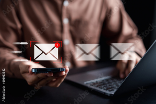 Businessman sending email by laptop computer to customer, business contact and communication, email icon, email marketing concept, send e-mail or newsletter, online working internet network...