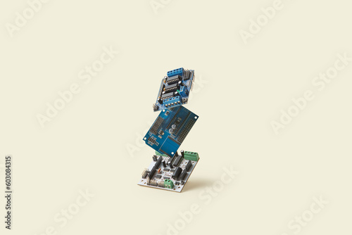 Electronic circuit boards on beige background.