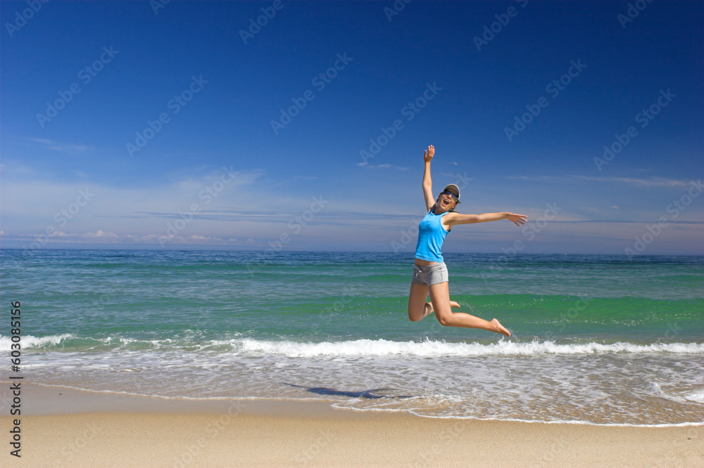 Beautiful young woman jumping on a beautiful beach Beautiful young woman jumping on a beautiful beach