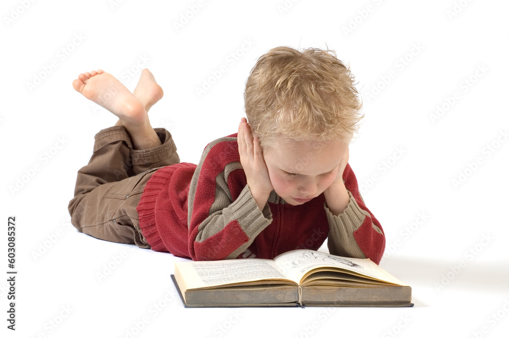 5 year old reading a book, isolated on white. Book is an old children's Bible. 5 year old reading a book, isolated on white. Book is an old children's Bible.