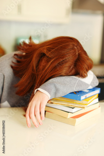 The girl studying hard, she so tried and sleeping with books on table. Learning for idea to success concept.