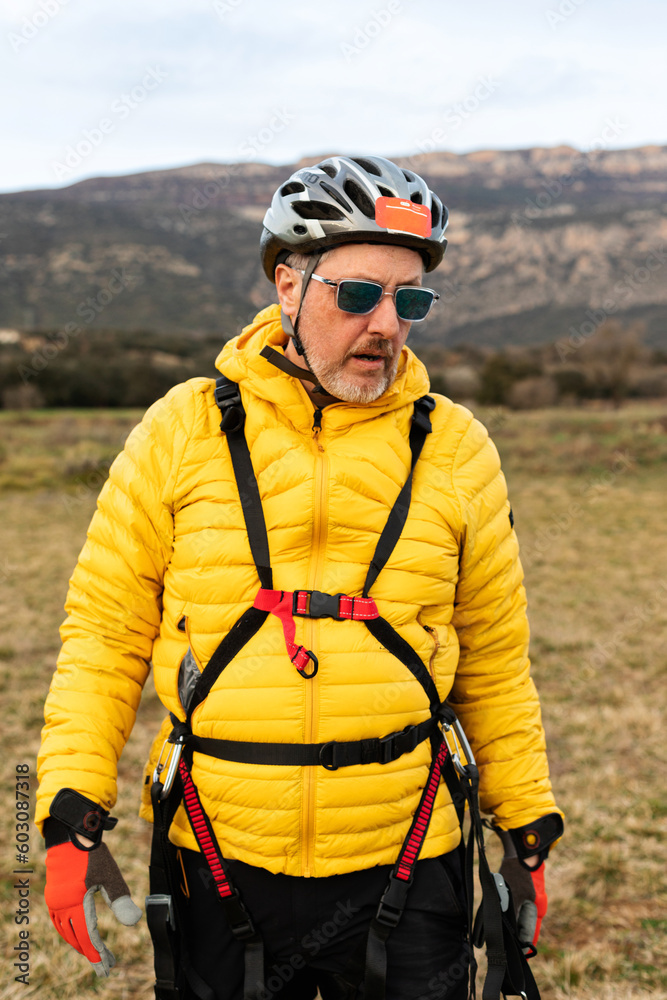 mature man with paragliding equipment mature man with paragliding equipment