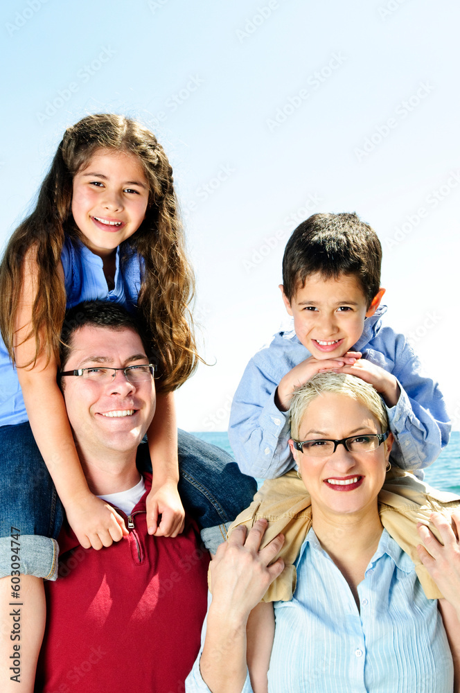 Happy family having fun giving shoulder rides Happy family having fun giving shoulder rides