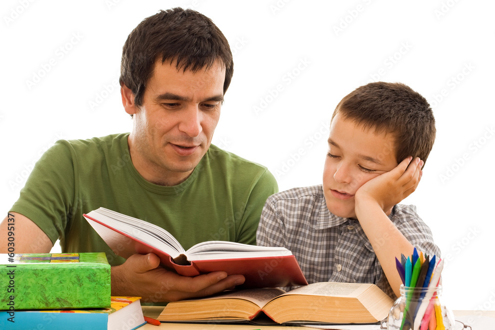 Schoolboy sleeping while his father reading from a red color book - isolated Schoolboy sleeping while his father reading from a red color book - isolated