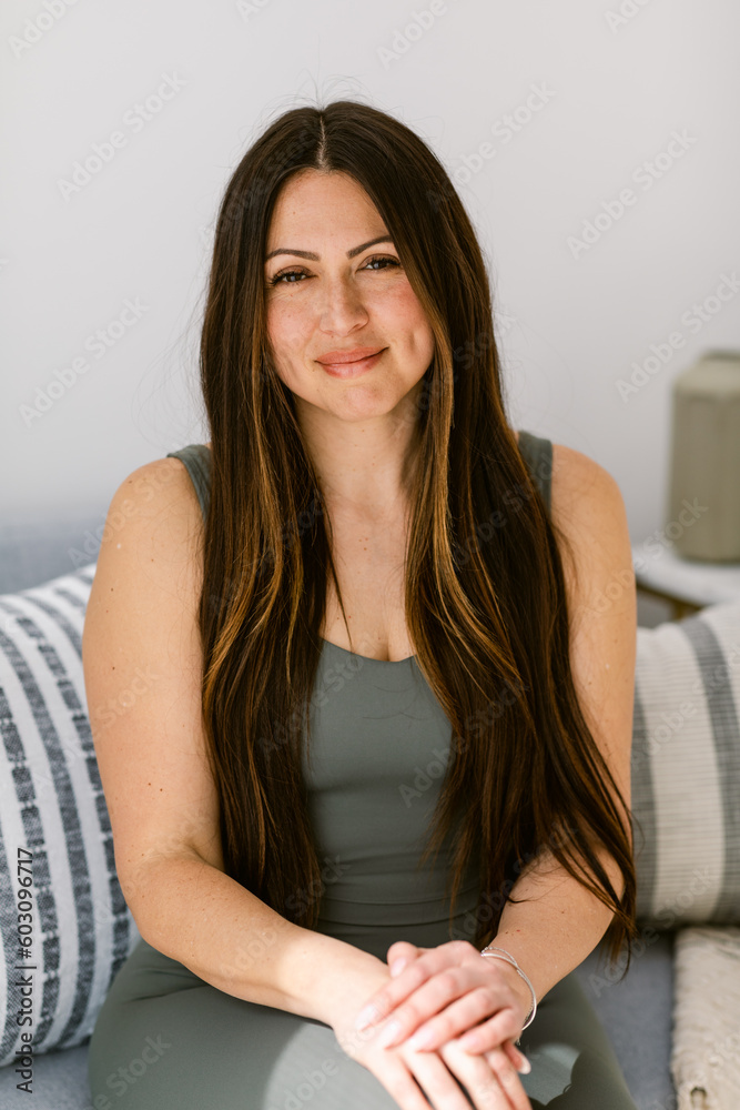 Portrait of latin wellness woman with sportwear in home office Portrait of latin wellness woman with sportwear in home office