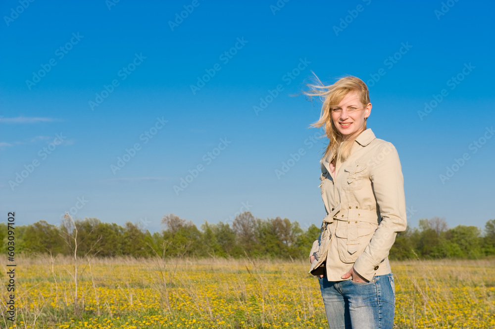 The young smiling girl standing on field The young smiling girl standing on field