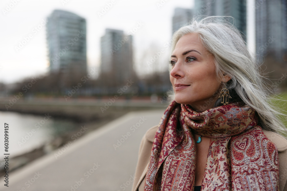 Stylish woman outside wearing jacket and scarf in winter. Stylish woman outside wearing jacket and scarf in winter.