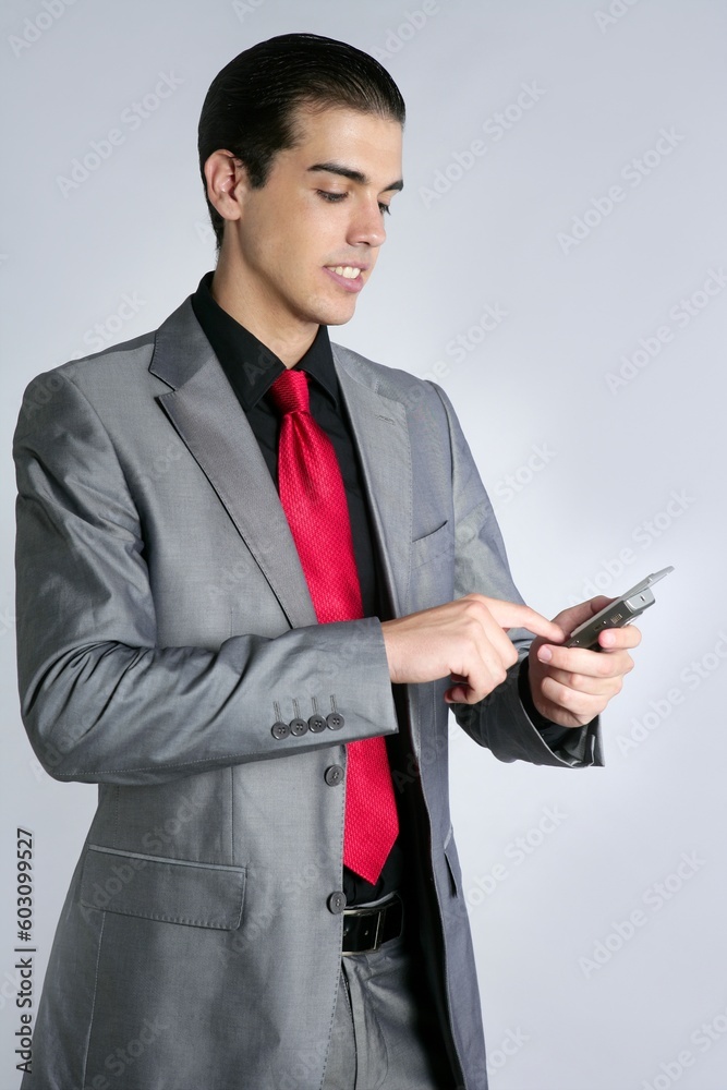 Businessman with gray suit talking cellular phone with suit and red tie Businessman with gray suit talking cellular phone with suit and red tie