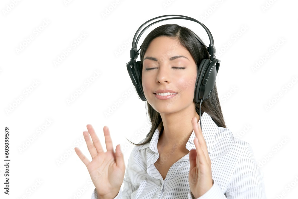 Beautiful brunette businesswoman hearing music on headphones Beautiful brunette businesswoman hearing music on headphones