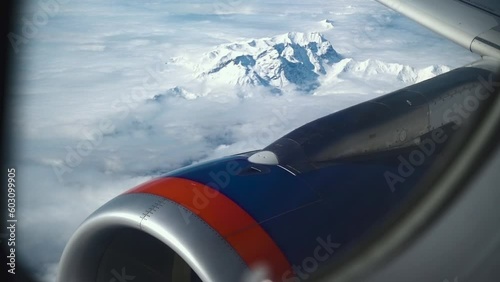 Scenic aerial view of snowy winter mountains and turbina from airplane window. Ice mountain range landscape. Majectic high angle view of mountain frozen peaks. Concept of mountaineering and geology. photo