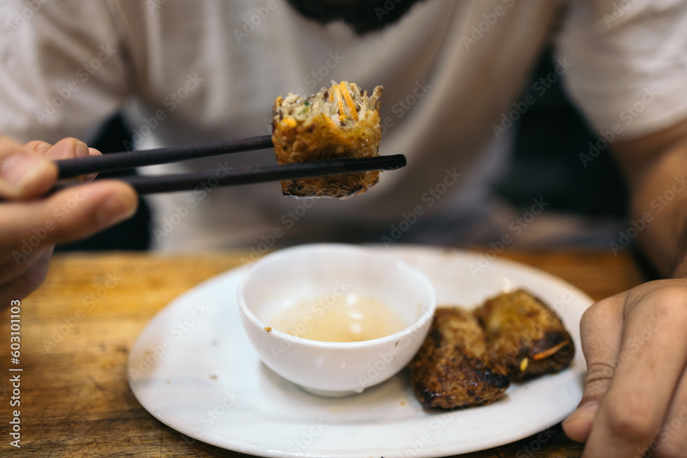 Caucasian man eating oriental food in Southeast Asia Caucasian man eating oriental food in Southeast Asia