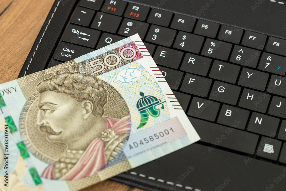 E-commerce business, Poland, money on tablet keyboard, 500 Polish zloty banknote, Shopping and online stores, concept, online market, Payments and bank transfers in Poland E-commerce business, Poland, money on tablet keyboard, 500 Polish zloty banknote, Shopping and online stores, concept, online market, Payments and bank transfers in Poland
