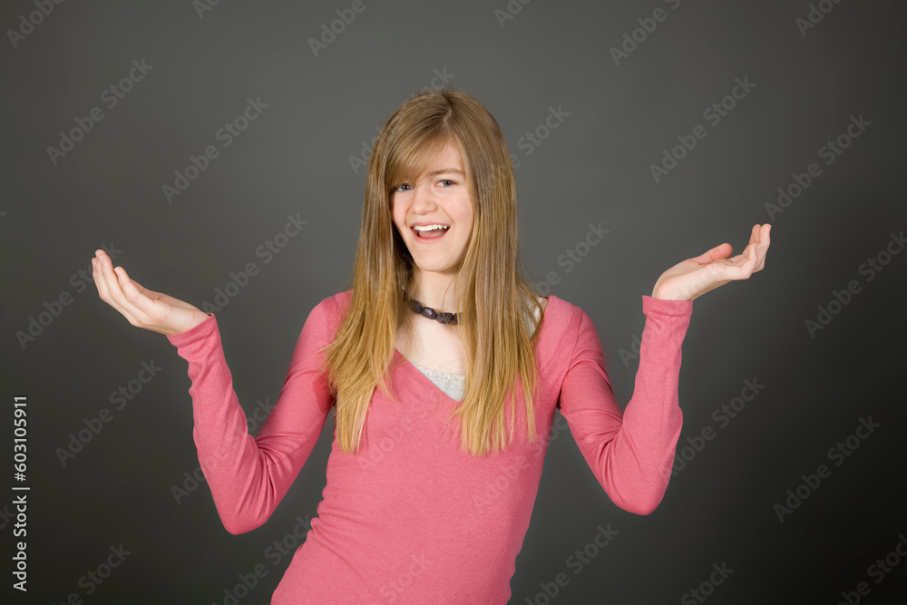 Preteen girl posing on gray background with some attitude Preteen girl posing on gray background with some attitude
