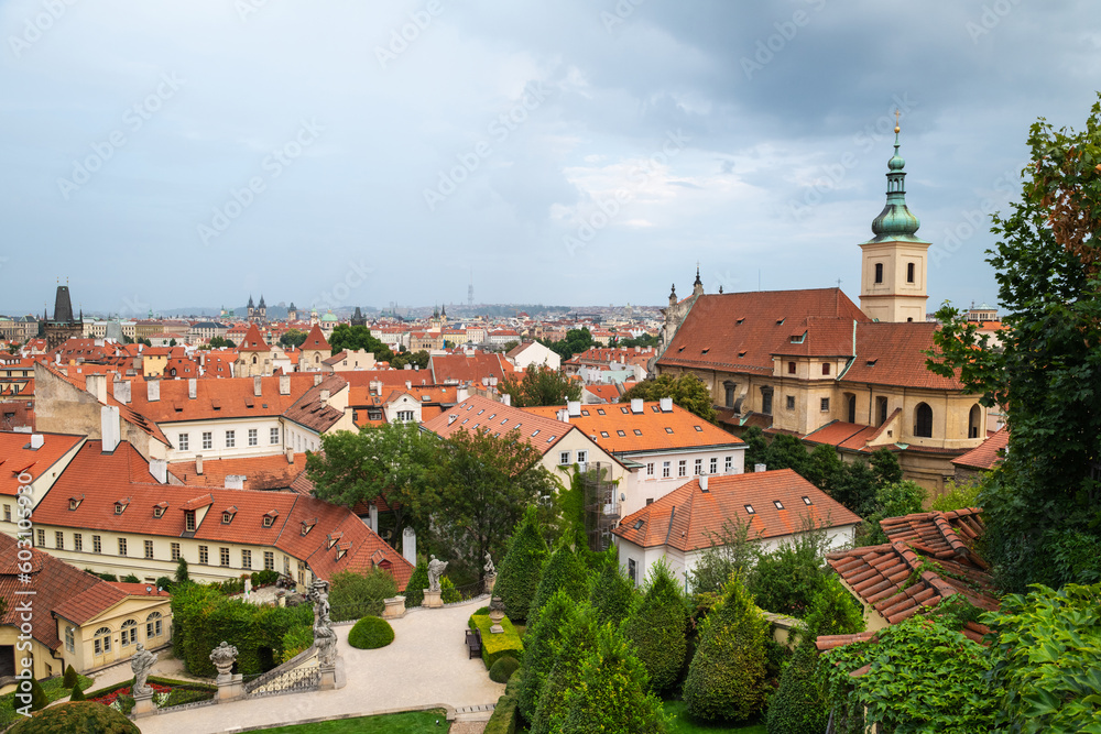 Aerial panoramic view of Prague against a cloudy sky.