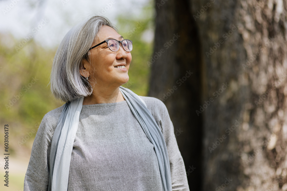 Smiling aged woman enjoying sunny day Smiling aged woman enjoying sunny day