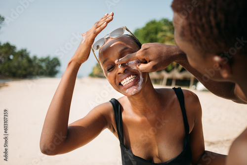 Man Applying Lotion on Woman's Face