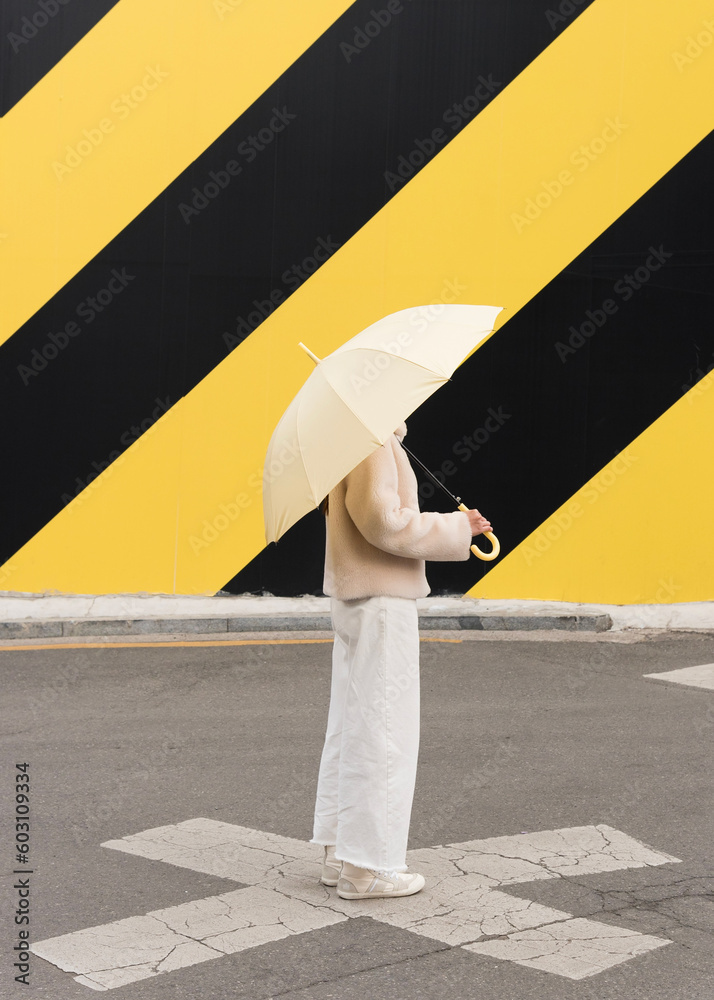 A woman with umbrella walking on the street A woman with umbrella walking on the street