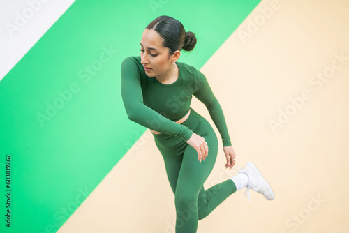 ballerina dancing in front of a colorful background in the city photo