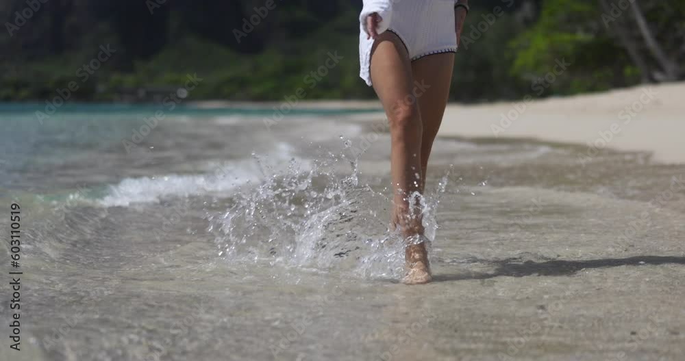 Woman happy walking and running on a beach in paradise Hawaii in slow motion Woman happy walking and running on a beach in paradise Hawaii in slow motion