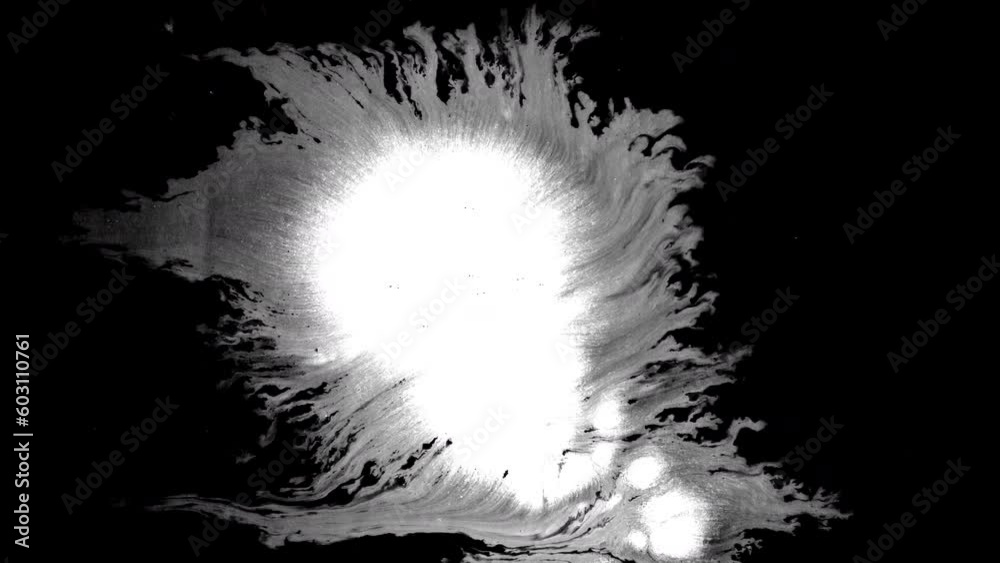 Black ink spills onto white paper, forming beautiful streaks beautiful black watercolor ink drops transition