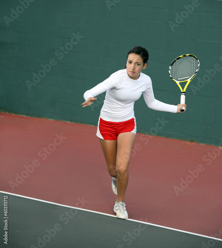 A pretty asian teenage girl playing tennis © Designpics
