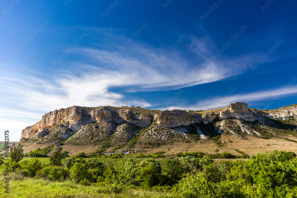 Rocky ledges, cuesta in hilly terrain, landscape on clear day