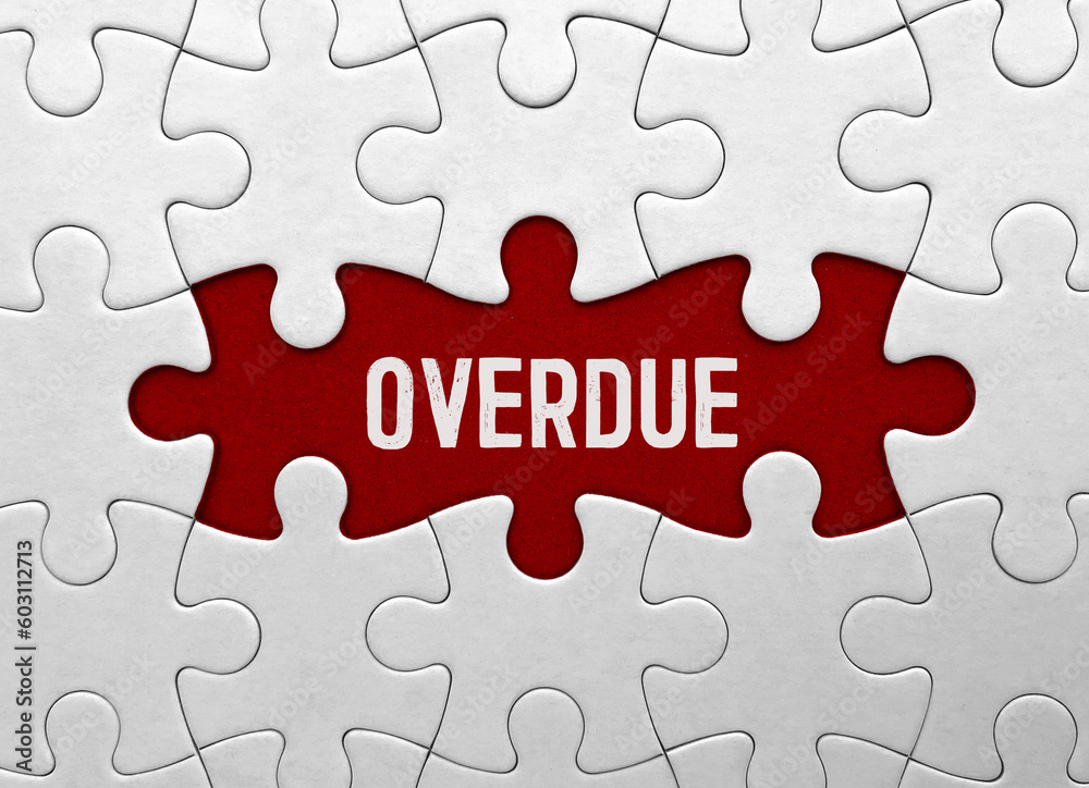 Word overdue on red puzzle background Word overdue on red puzzle background