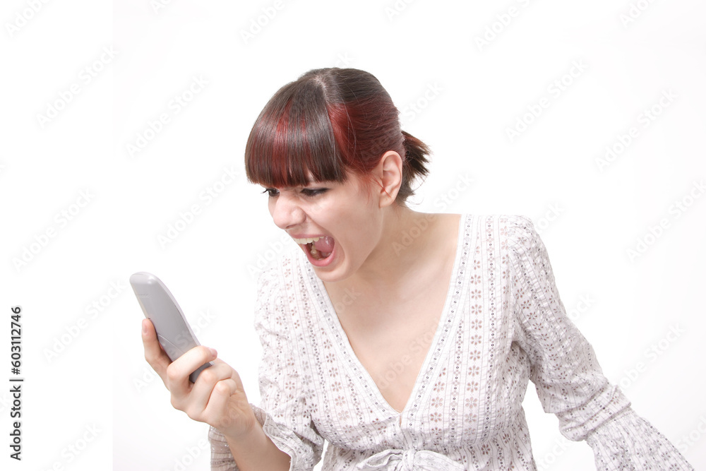 Closeup portrait of a happy young woman yealing on the phone isolated on white background Closeup portrait of a happy young woman yealing on the phone isolated on white background