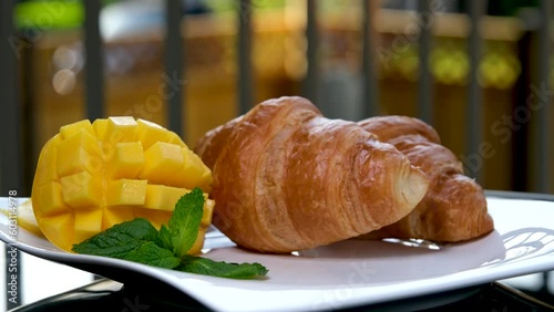 mango croissant delicious breakfast with croissant, fruit and coffee cup. High quality 4k footage photo