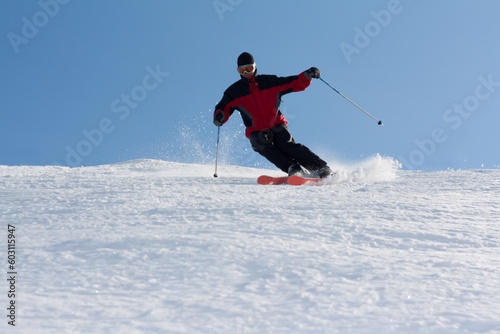 Man in red jacket goes on mountain ski