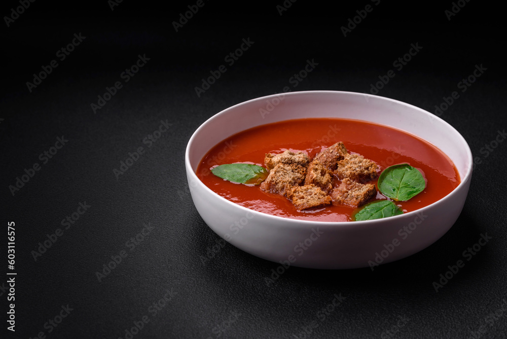 Delicious fresh gazpacho with breadcrumbs, salt and spices in a ceramic plate Delicious fresh gazpacho with breadcrumbs, salt and spices in a ceramic plate