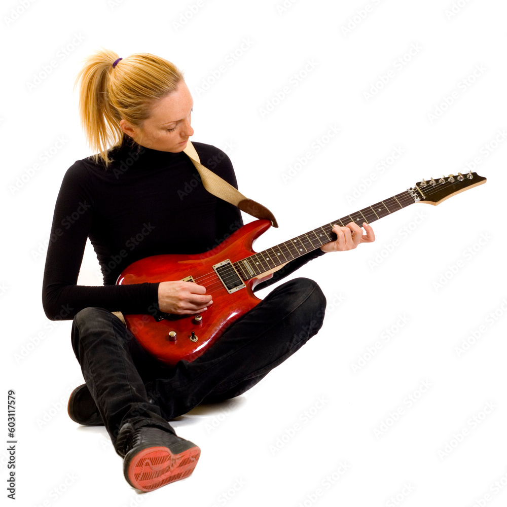 passionate rock girl playing an electric guitar sitting down passionate rock girl playing an electric guitar sitting down