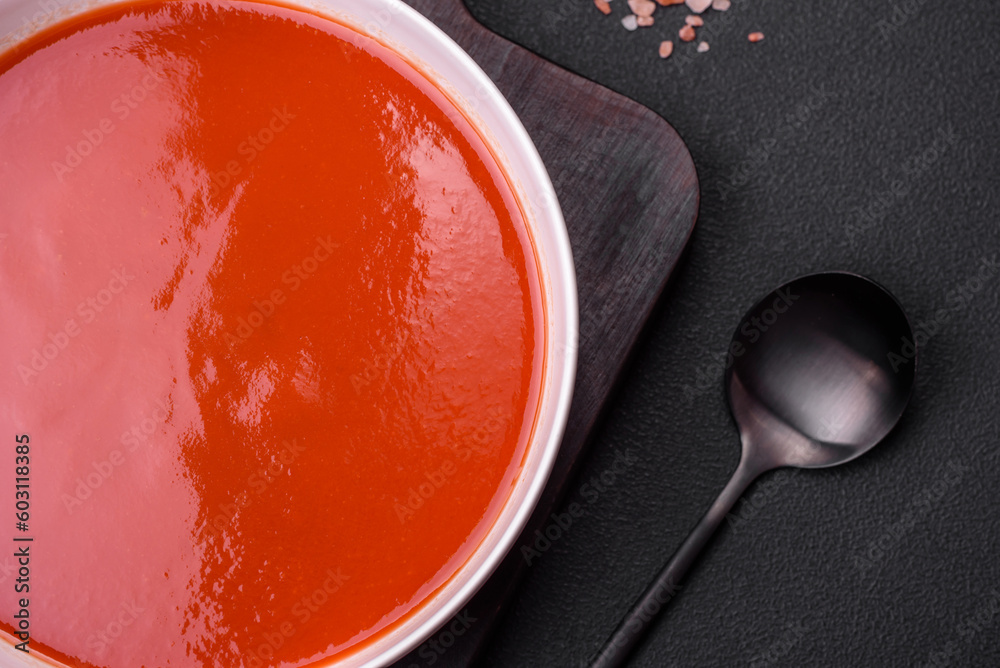 Delicious fresh gazpacho with breadcrumbs, salt and spices in a ceramic plate Delicious fresh gazpacho with breadcrumbs, salt and spices in a ceramic plate