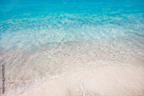 Sea surf with clear turquoise water on a sandy beach