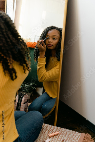 young woman with long surly hair getting ready 