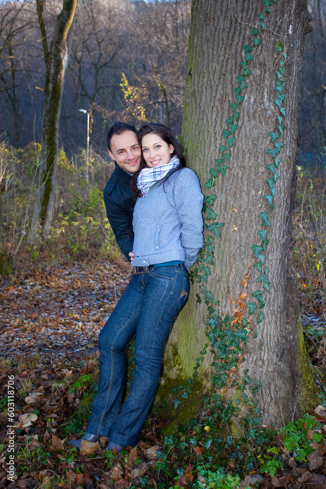 Young couple playing around in the nature - front view.