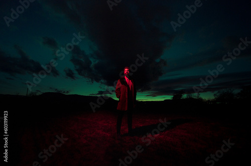Standing man in dreamlike dark field photo